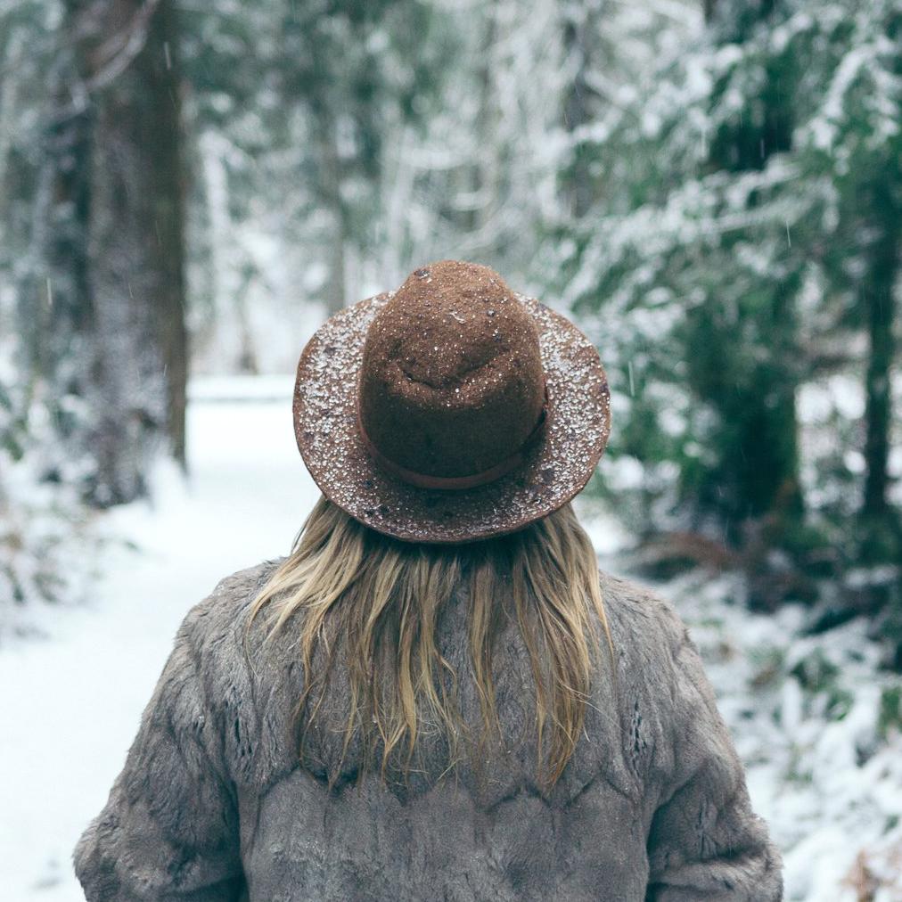 Woman outdoors in snow wearing a hat.