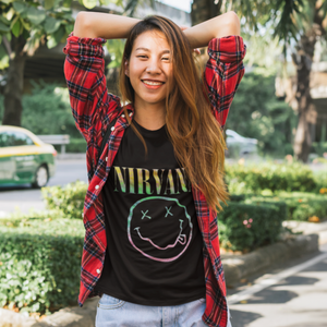 Nirvana women's t-shirt with pastel smiley graphic on a grungy styled model.