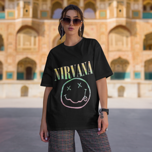 Nirvana women's t-shirt with pastel smiley graphic on a stylish model.