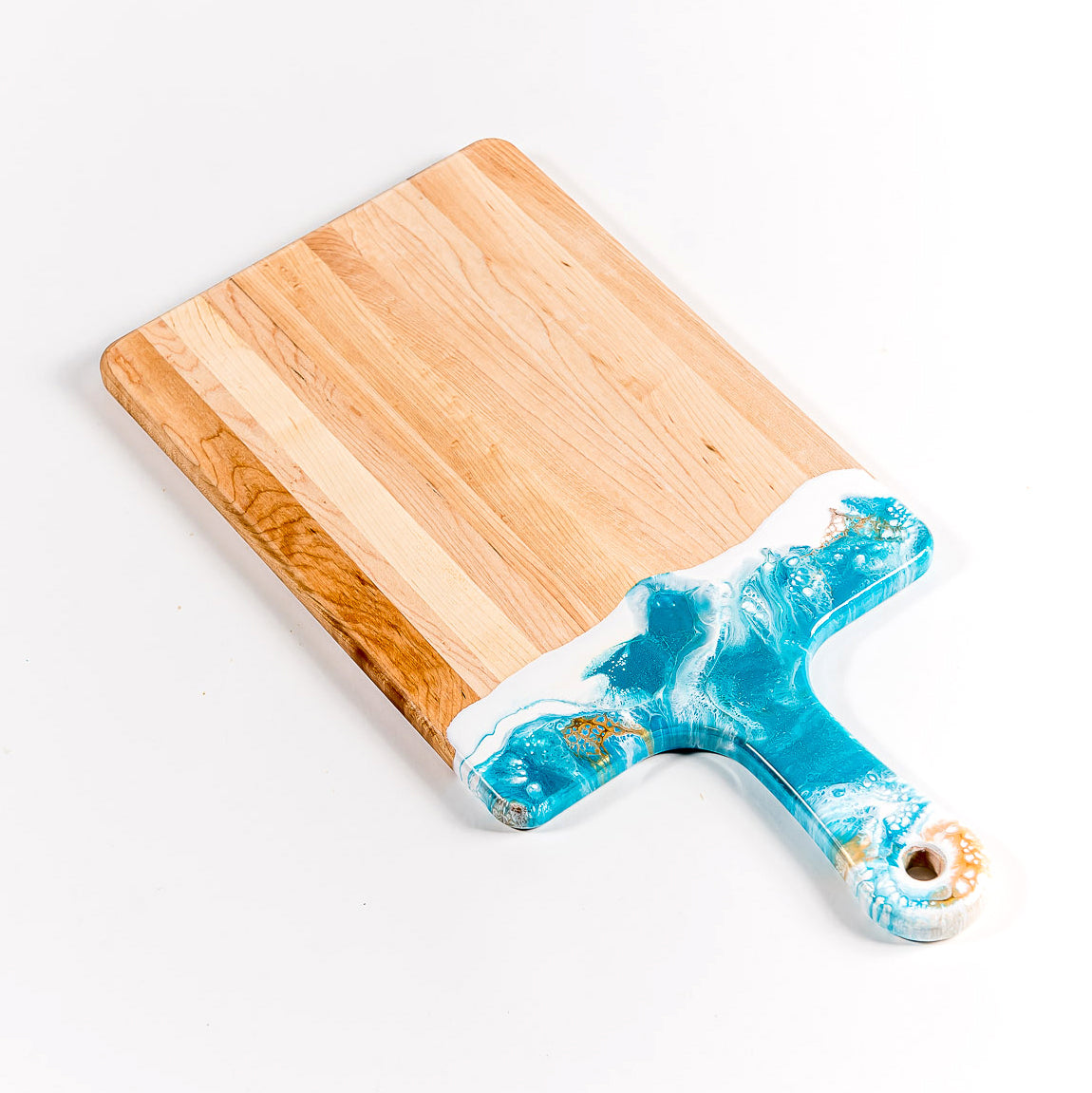 Acacia Resin Cheeseboard in teal, white, and gold.