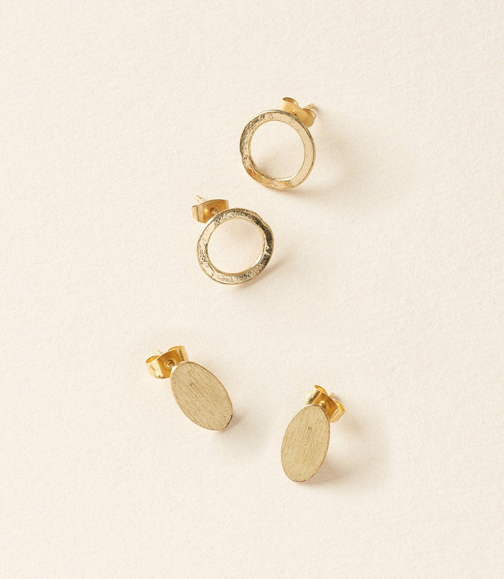 Diya style brass stud earrings in Circle and Oval shape, on cream. 