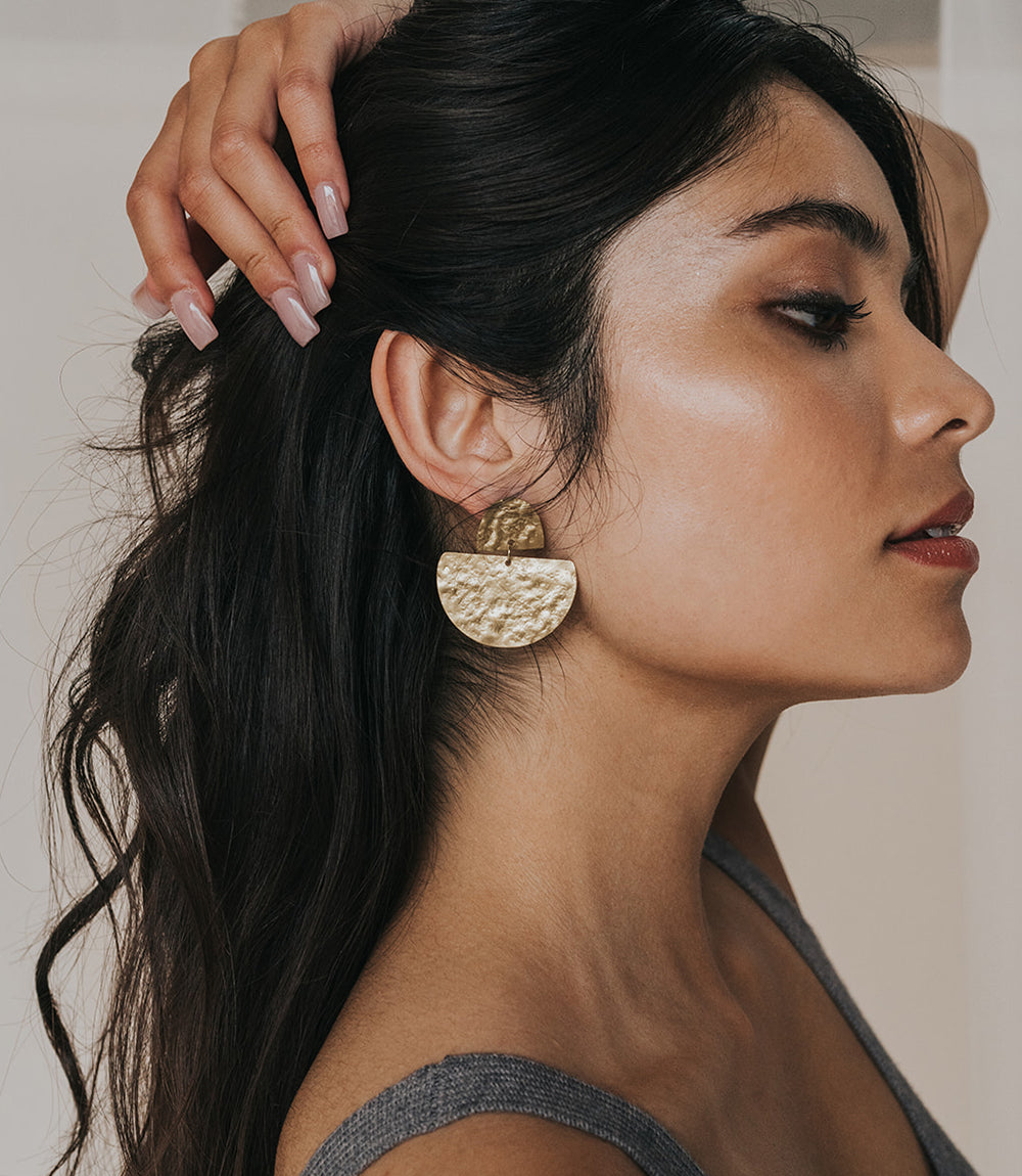 Matr Boomie Jayanti style gold stud earrings on model.