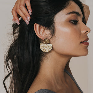 Matr Boomie Jayanti style gold stud earrings on model.