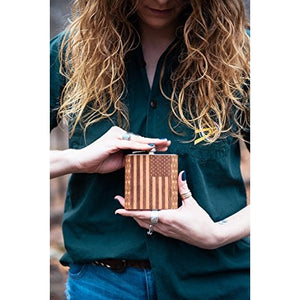 American flag wooden hip flask being held by woman.