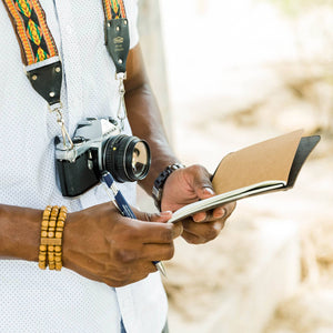 Photographer holding a leather journal. 